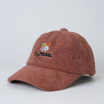 Brown fuzzy cap with embroidered design on a light gray background