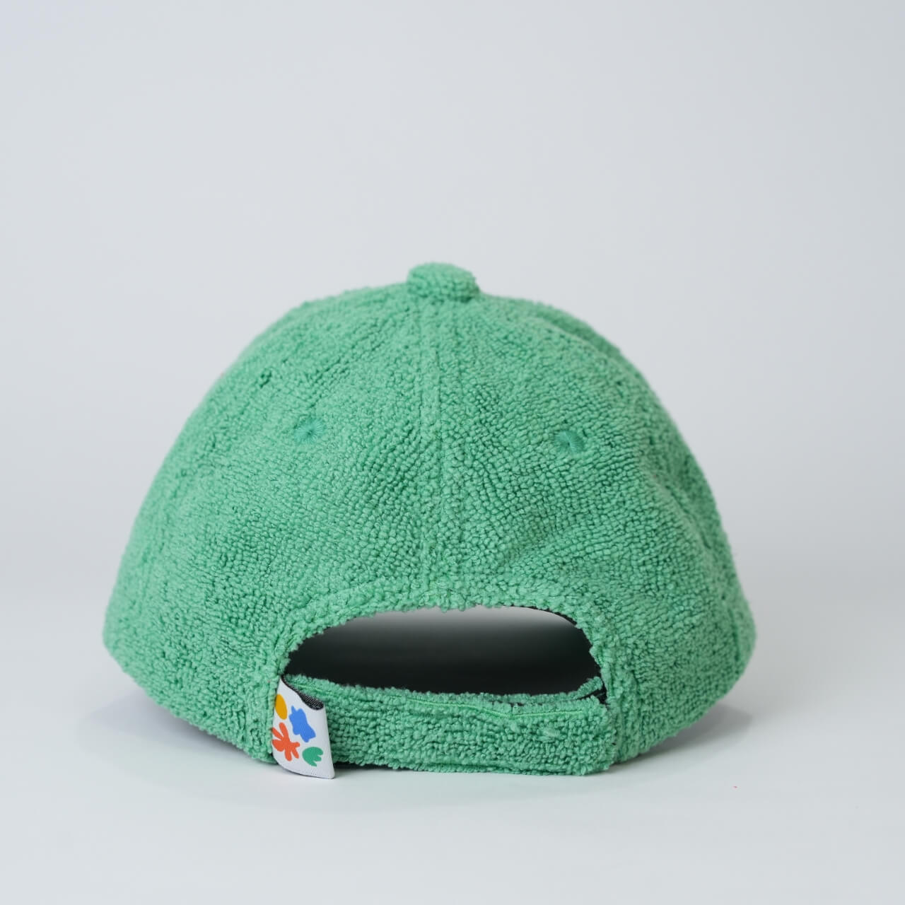 Green textured cap on a light gray background