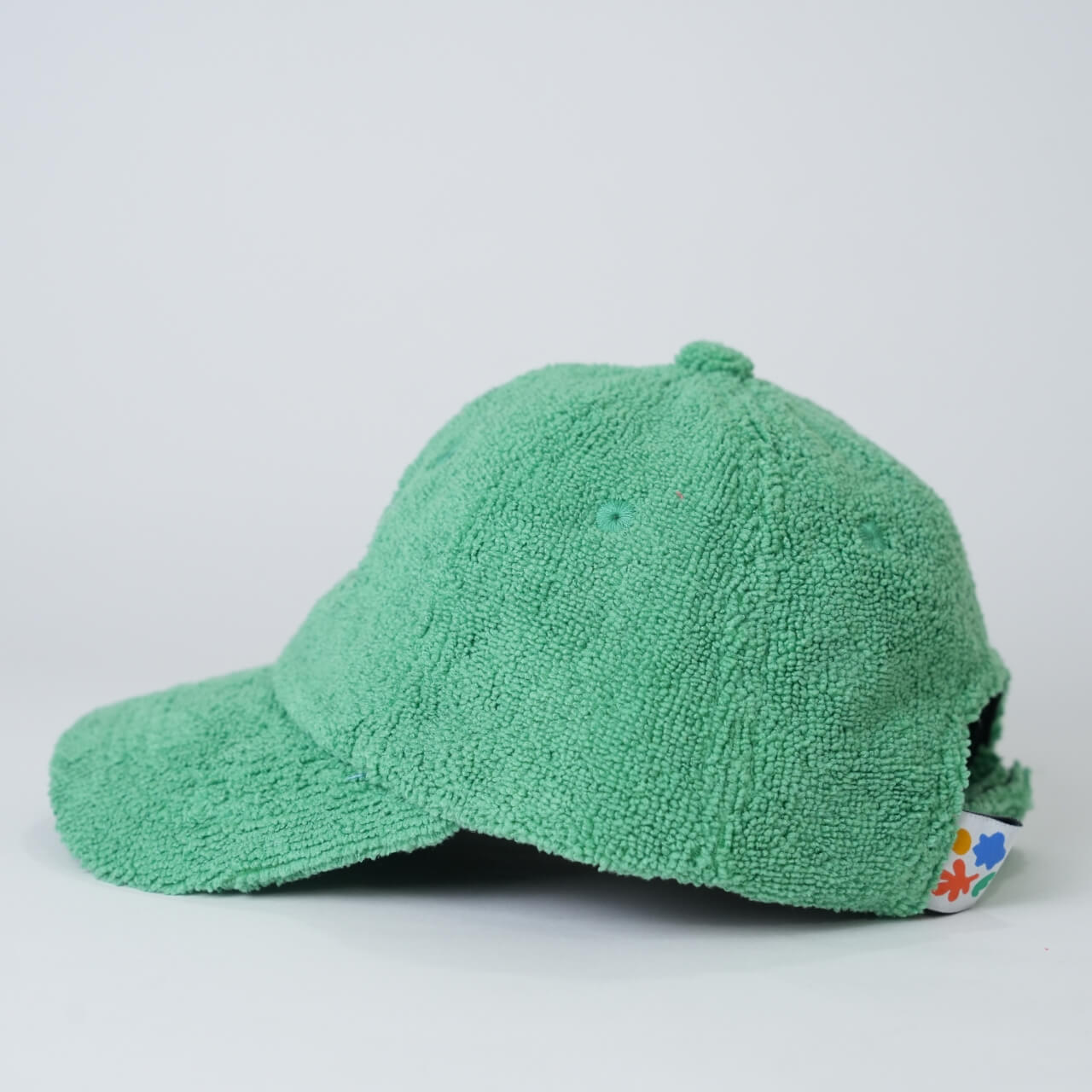 Green textured cap on a light gray background