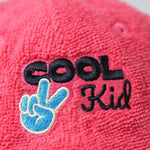 Red cap with 'COOL Kid' text and hand gesture logo on a light gray background