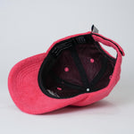 Red cap with black interior on a light gray background