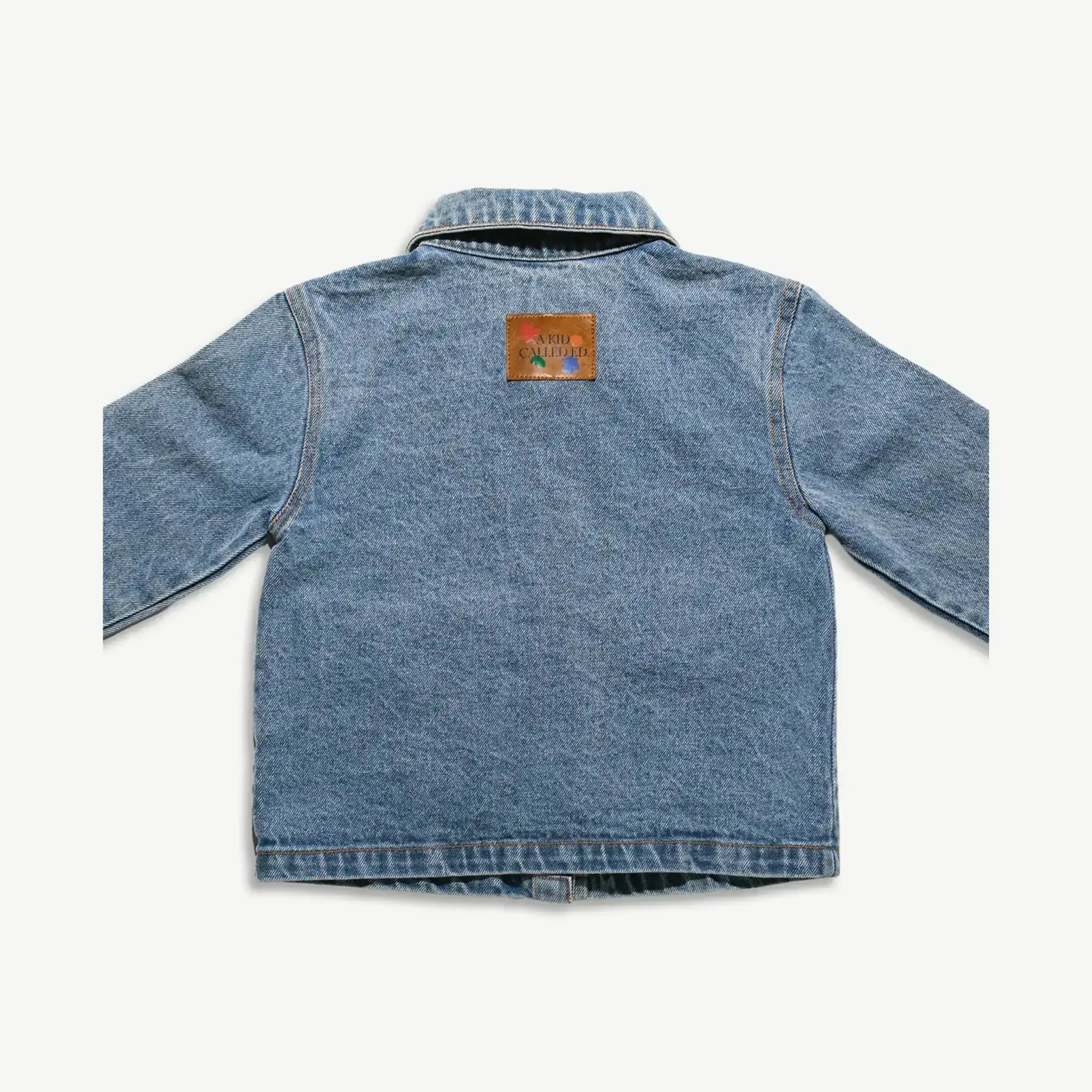 Back of the kids organic cotton denim jacket showing the leather logo patch