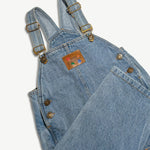 Kids organic cotton denim overalls styled with one leg folded