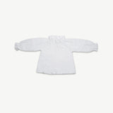 Organic cotton muslin long sleeve blouse for kids with a frill neck, laid flat