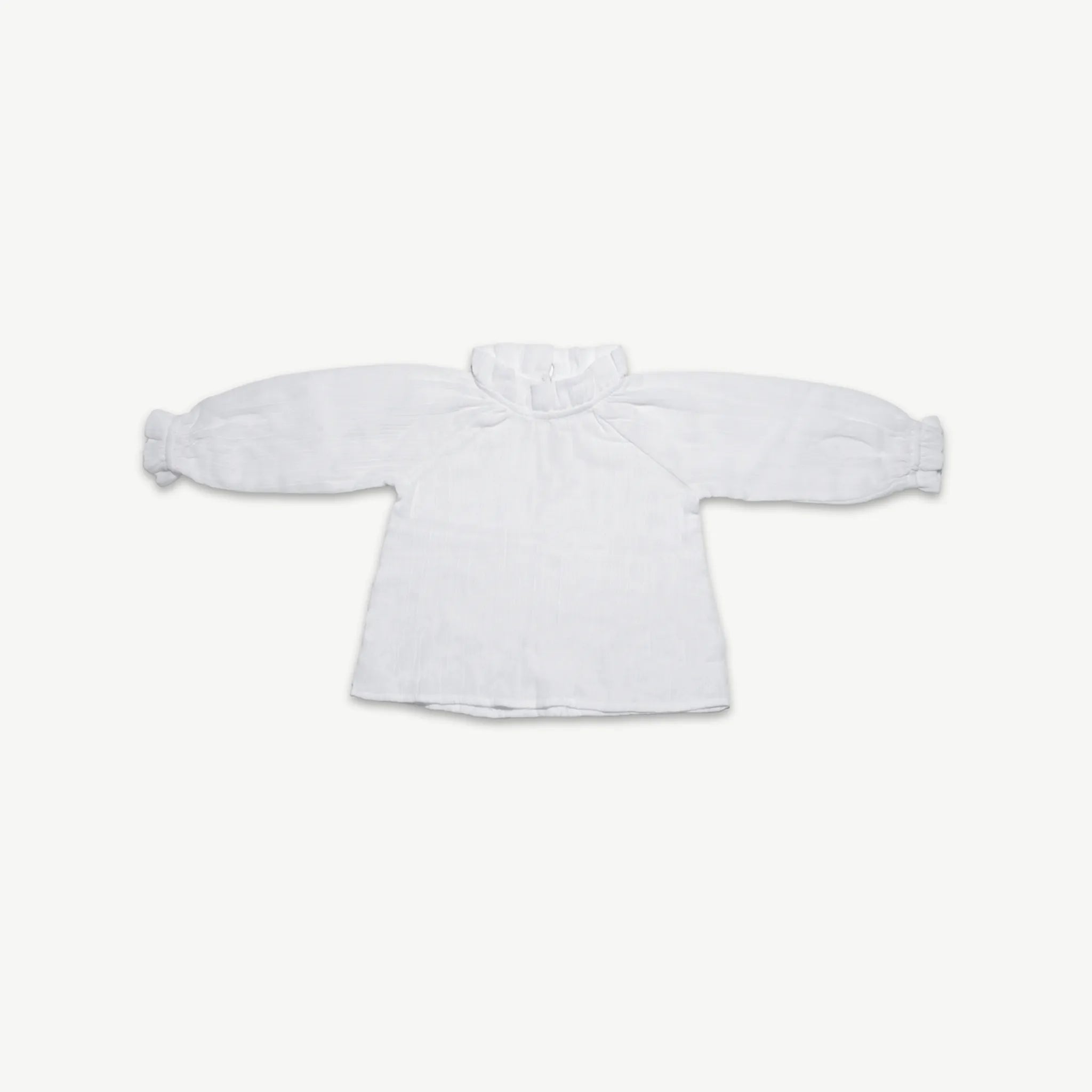 Organic cotton muslin long sleeve blouse for kids with a frill neck, laid flat