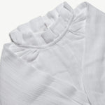 Close-up of the frill neckline on the organic cotton muslin blouse