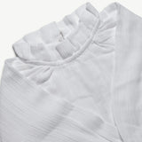 Close-up of the frill neckline on the organic cotton muslin blouse