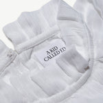 Close-up of the A Kid Called Ed woven label inside the muslin blouse