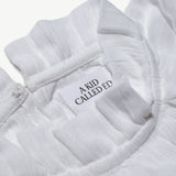 Close-up of the A Kid Called Ed woven label inside the muslin blouse