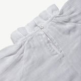 Close-up of the button placket on the organic cotton muslin blouse