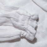 Close-up of the elasticated cuff on the long sleeve muslin blouse