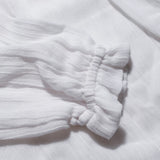 Close-up of the elasticated cuff on the long sleeve muslin blouse