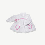 Organic cotton muslin long sleeve dress for kids with pink frilled heart pockets, front view