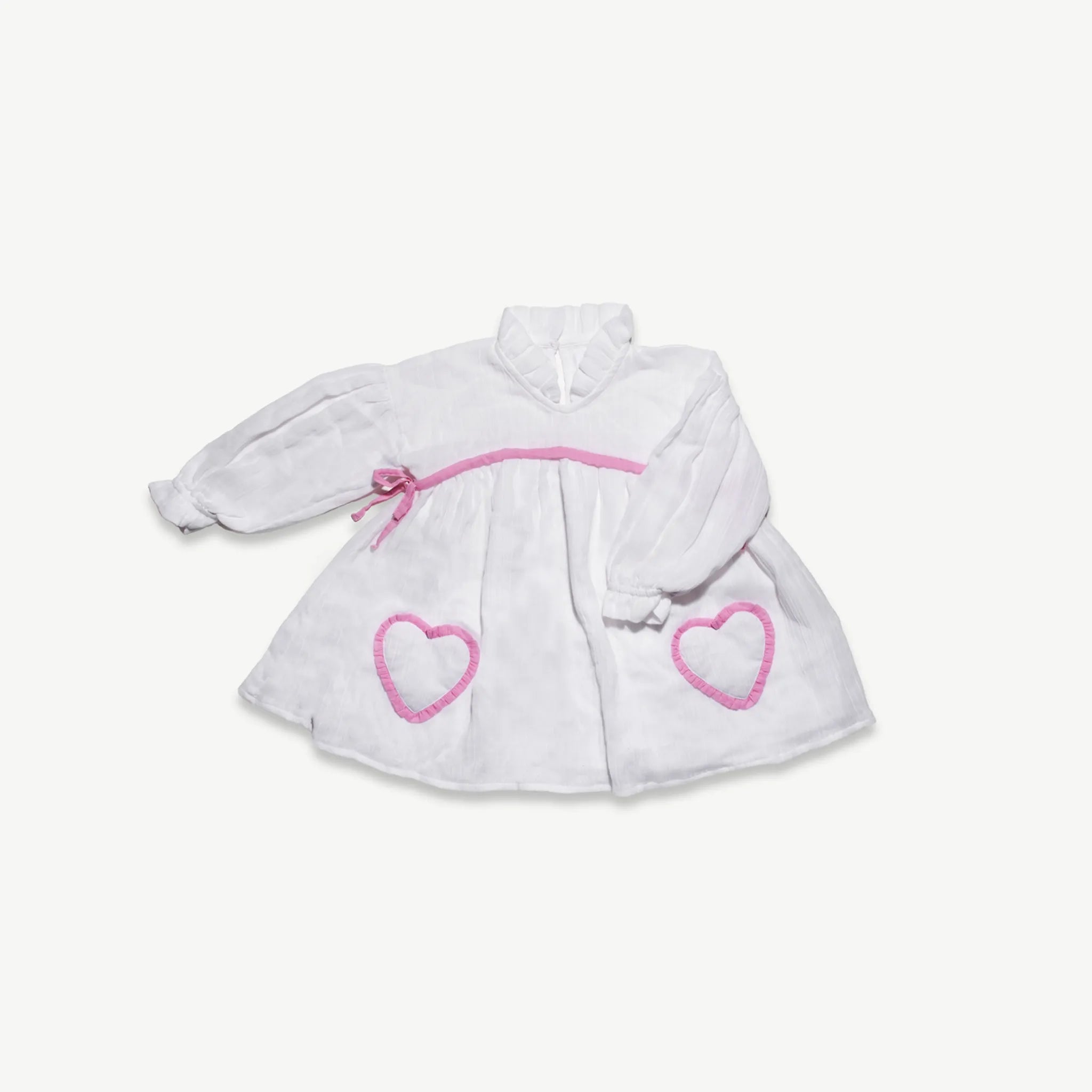 Organic cotton muslin long sleeve dress for kids with pink frilled heart pockets, front view