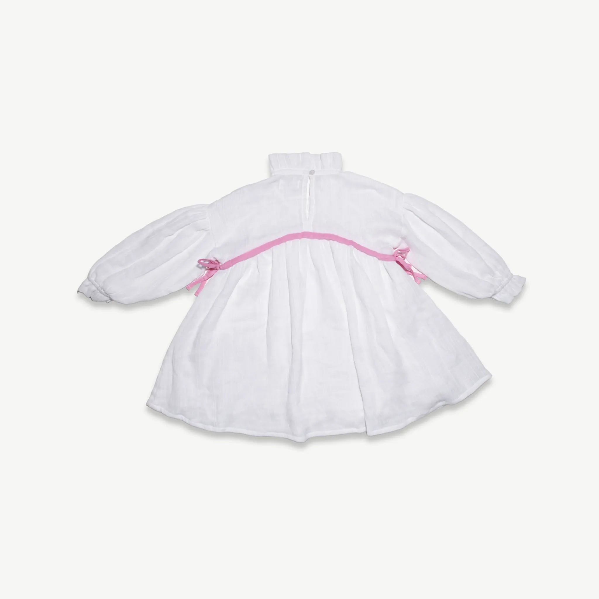 Back view of the kids organic cotton muslin dress with pink trim